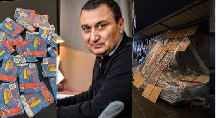 დათო ოქიტაშვილი ხალხს საწვიმარს ურიგებს